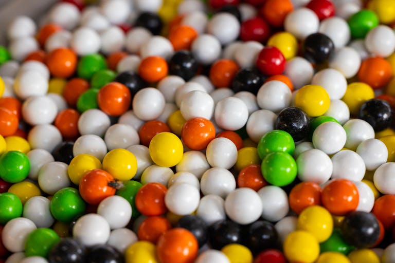 A vibrant close-up of colorful round gumballs, showcasing a mix of sweet treats.
