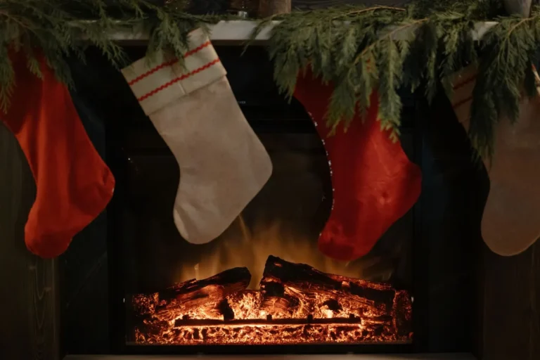 Knitted stockings filled with small gifts hanging by a fireplace